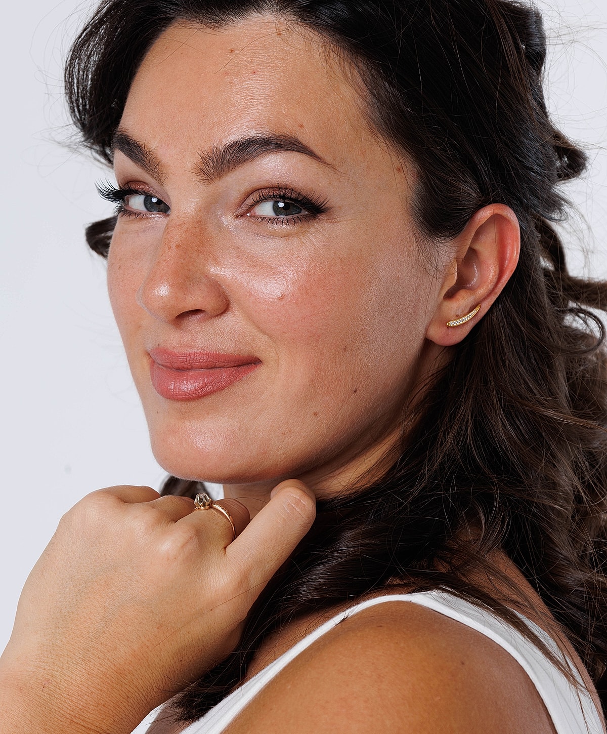 Smiling Melbourne brow lift model with elegant jewelry and hairstyle.