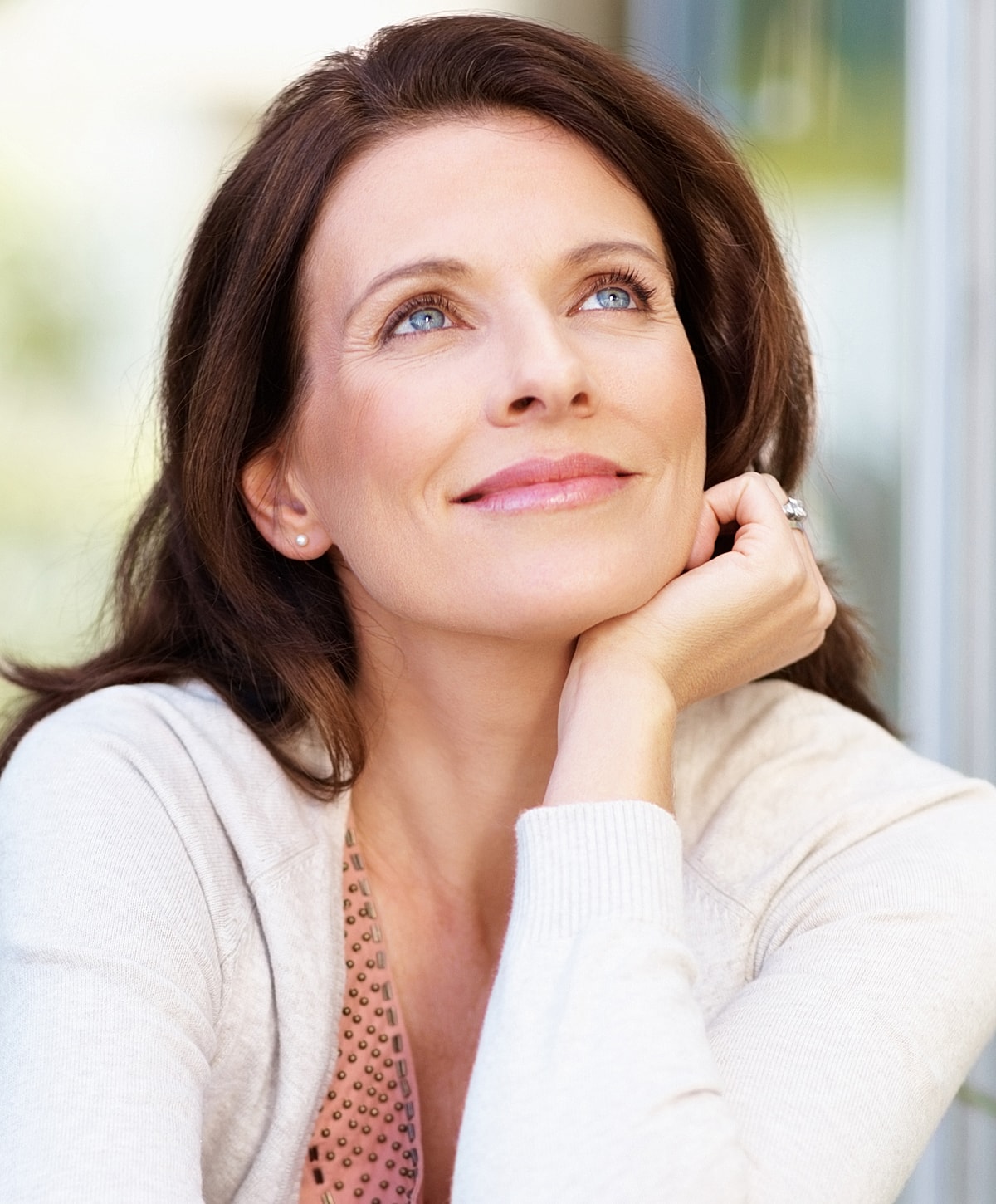 Melbourne neck lift model looking thoughtfully with a serene expression.