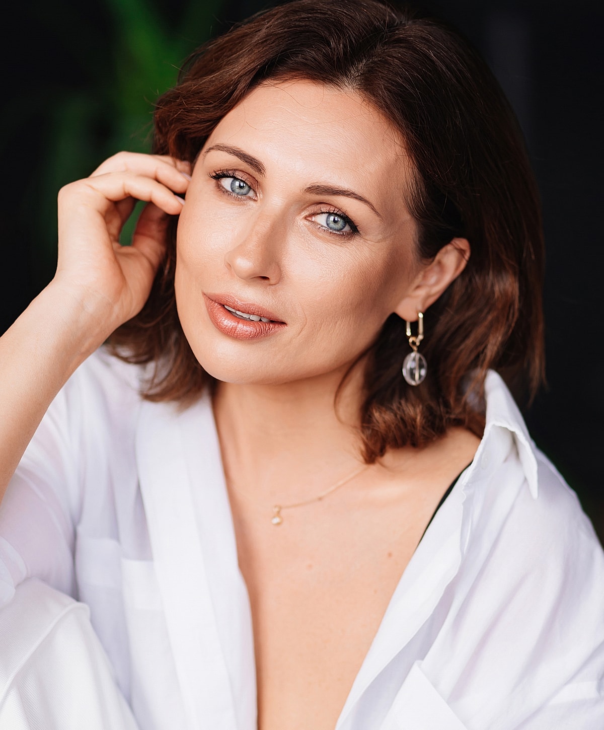 Melbourne scar revision model in a white shirt smiling softly.