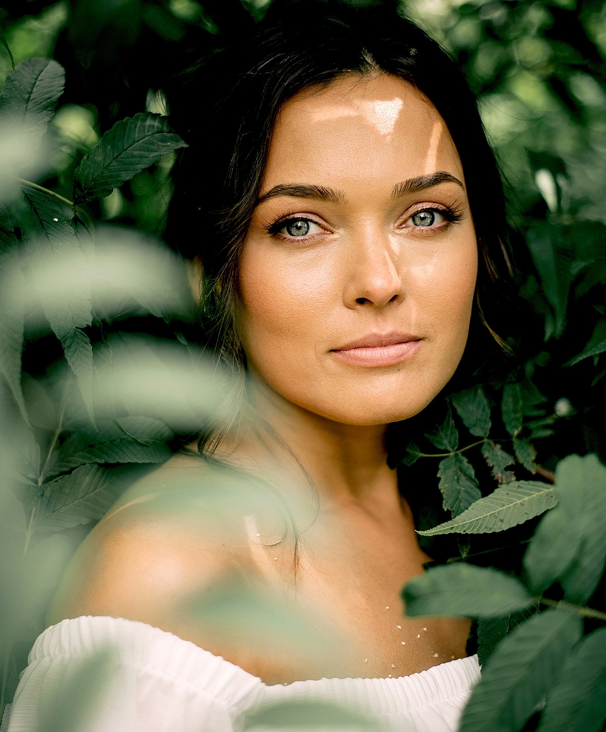 Melbourne PRP model with beautiful eyes among green foliage.