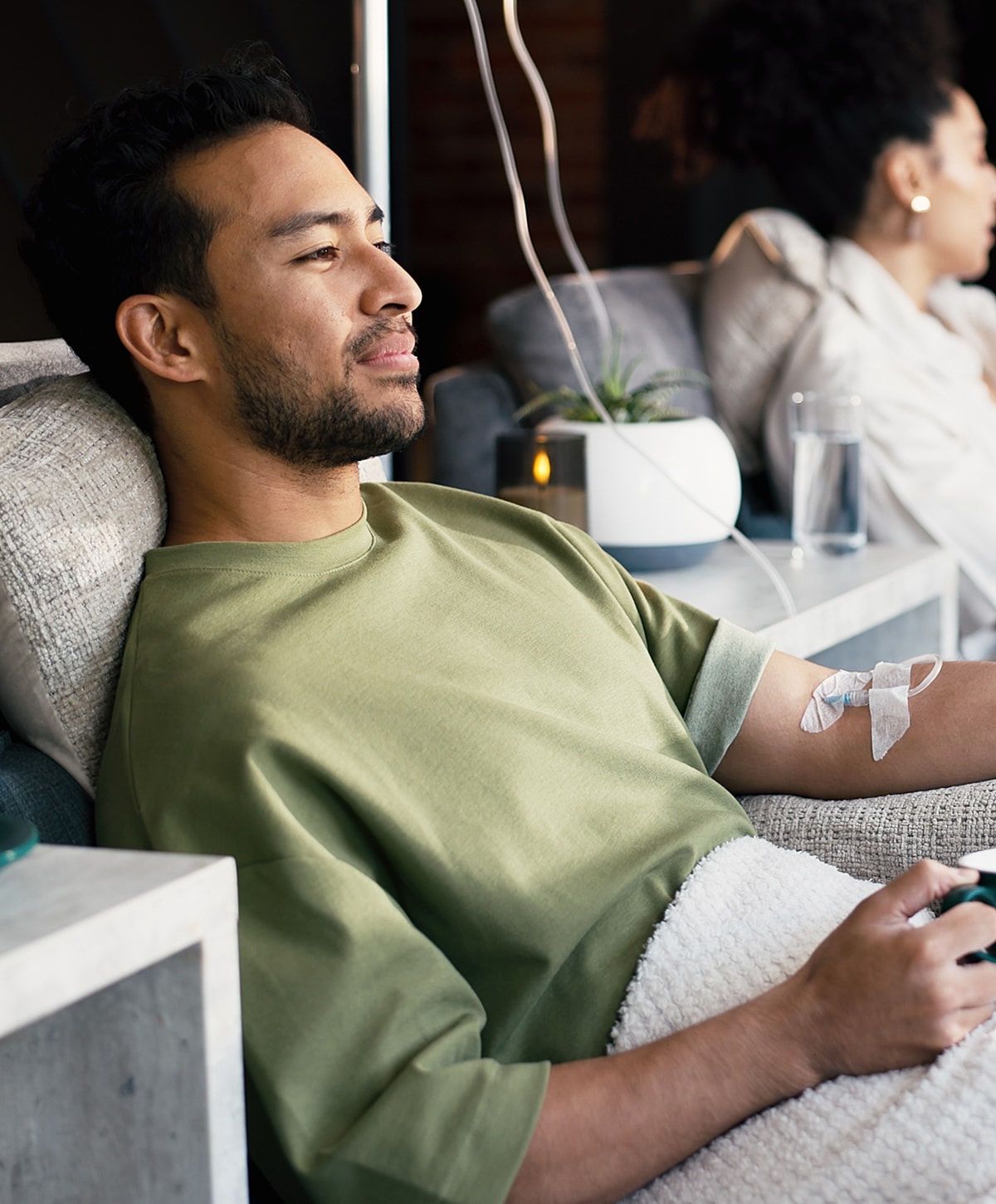 Man relaxing while receiving an IV treatment.