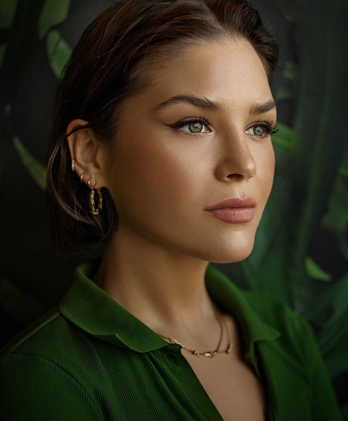 Melbourne otoplasty model with green eyes in a green top.