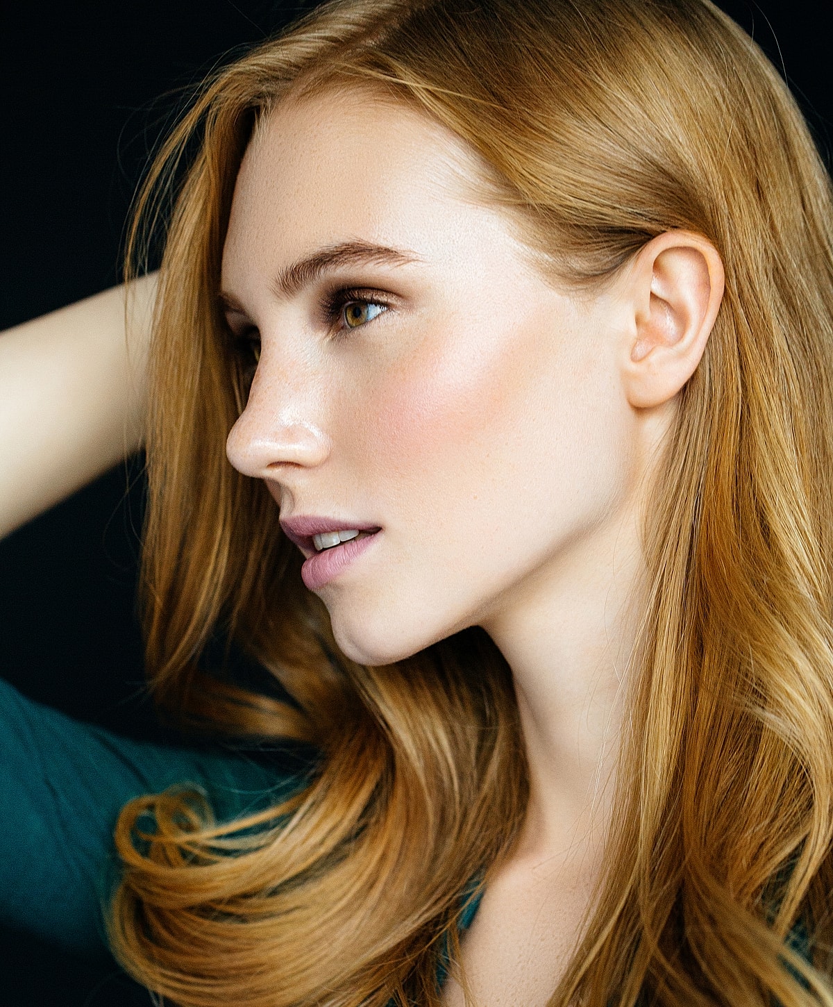 Profile of a Melbourne otoplasty model with long, wavy hair.
