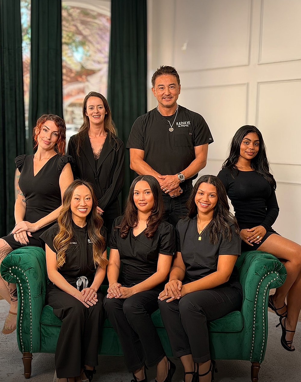 RENEW Facial Cosmetic Surgery & Aesthetics team posing together in black scrubs.